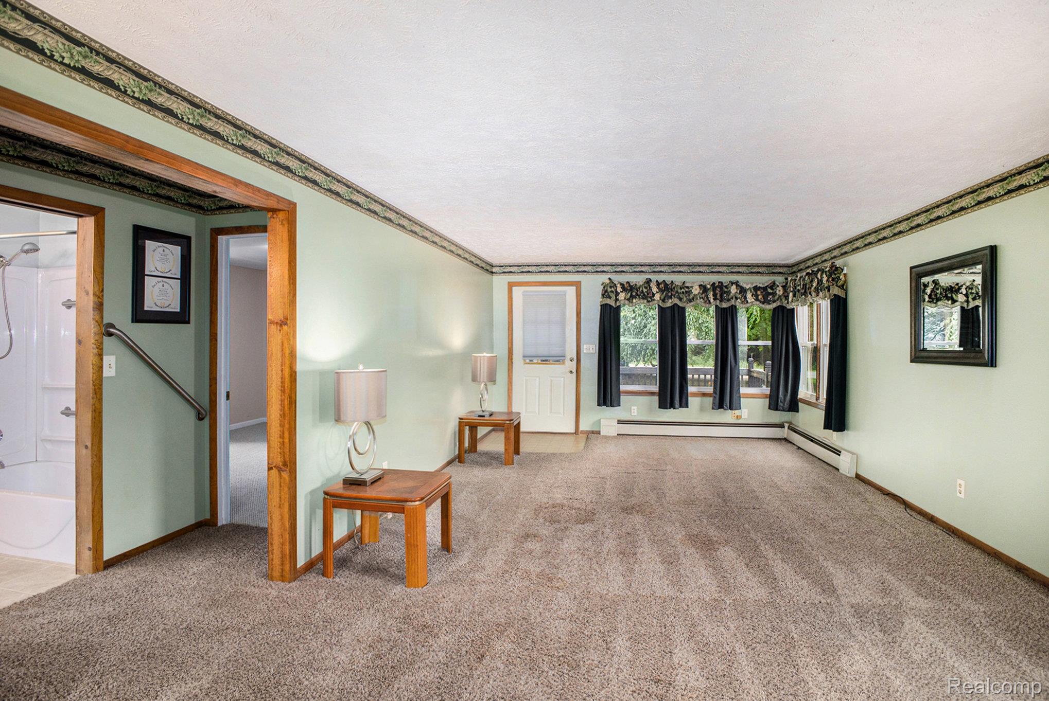 16568 28 Mile Road Albion, MI 49224 - Photo 3 of 26 Living area with carpet flooring, ornamental molding, and a baseboard radiator