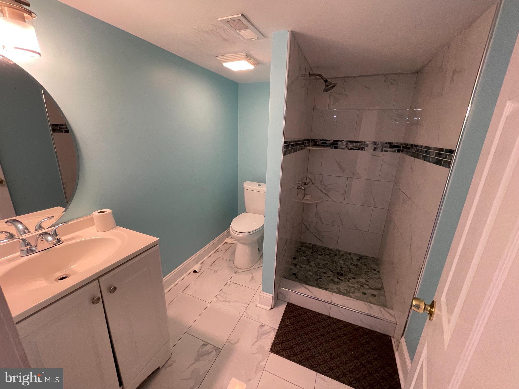 147 Lexington Avenue Lansdowne, PA 19050 - Photo 14 of 32 a bathroom with a sink and a mirror