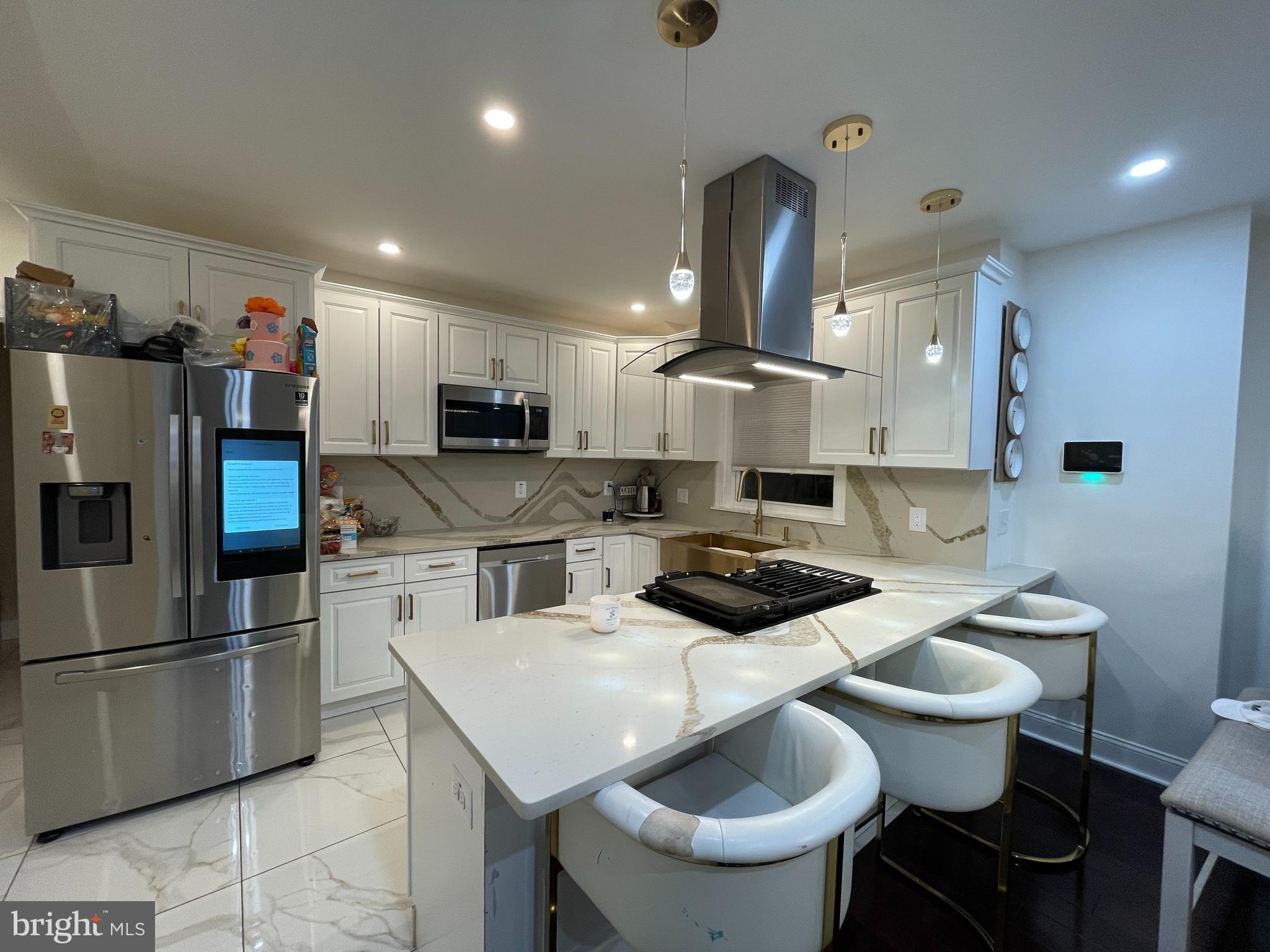 147 Lexington Avenue Lansdowne, PA 19050 - Photo 8 of 32 a kitchen with a sink a stove and chairs