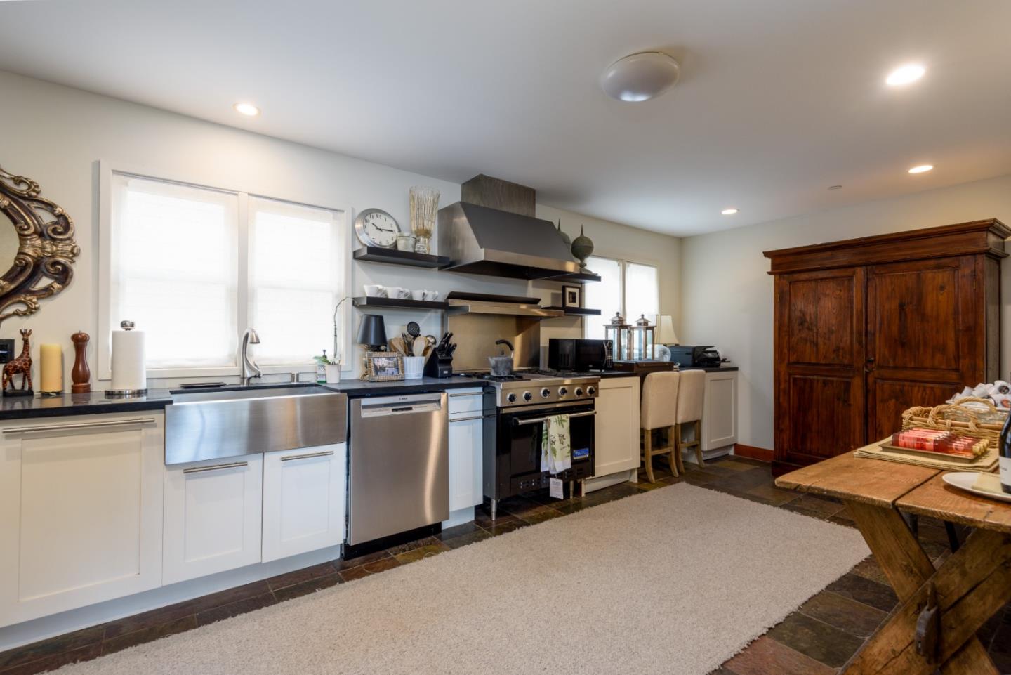 215 Mirada Road Half Moon Bay, CA 94019 - Photo 23 of 47 a kitchen with kitchen island granite countertop lots of counter top space and stainless steel appliances