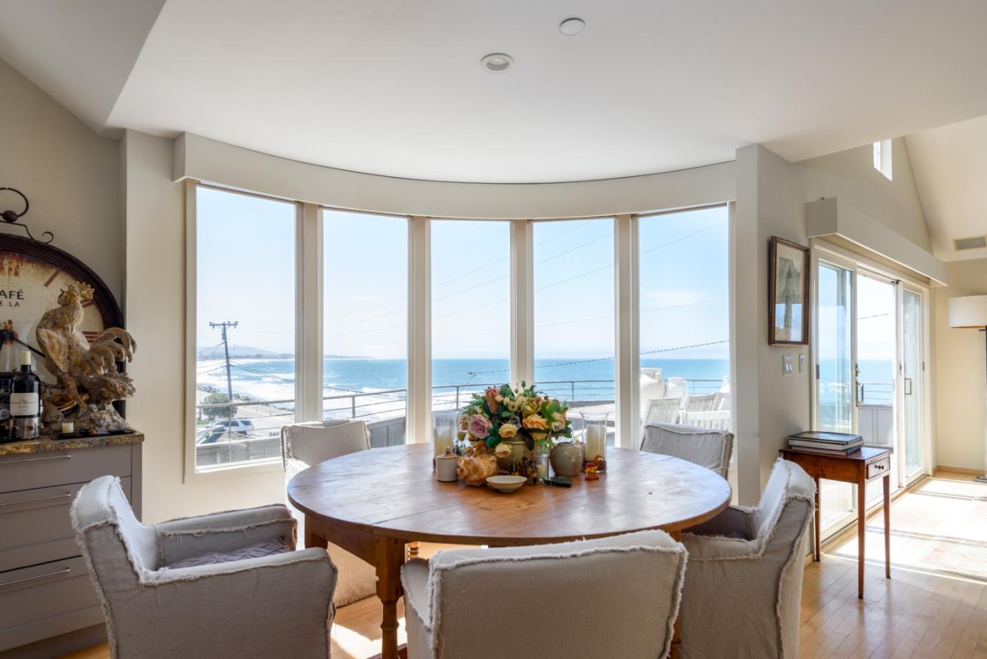 215 Mirada Road Half Moon Bay, CA 94019 - Photo 9 of 47 a dining room with furniture a large window and a chandelier