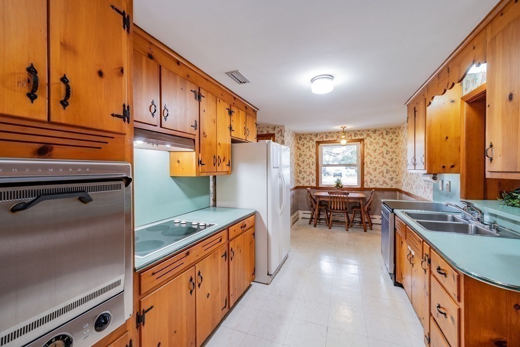 2495 Wilbraham Road Springfield, MA 01129 - Photo 14 of 42 a kitchen with stainless steel appliances granite countertop sink stove and refrigerator