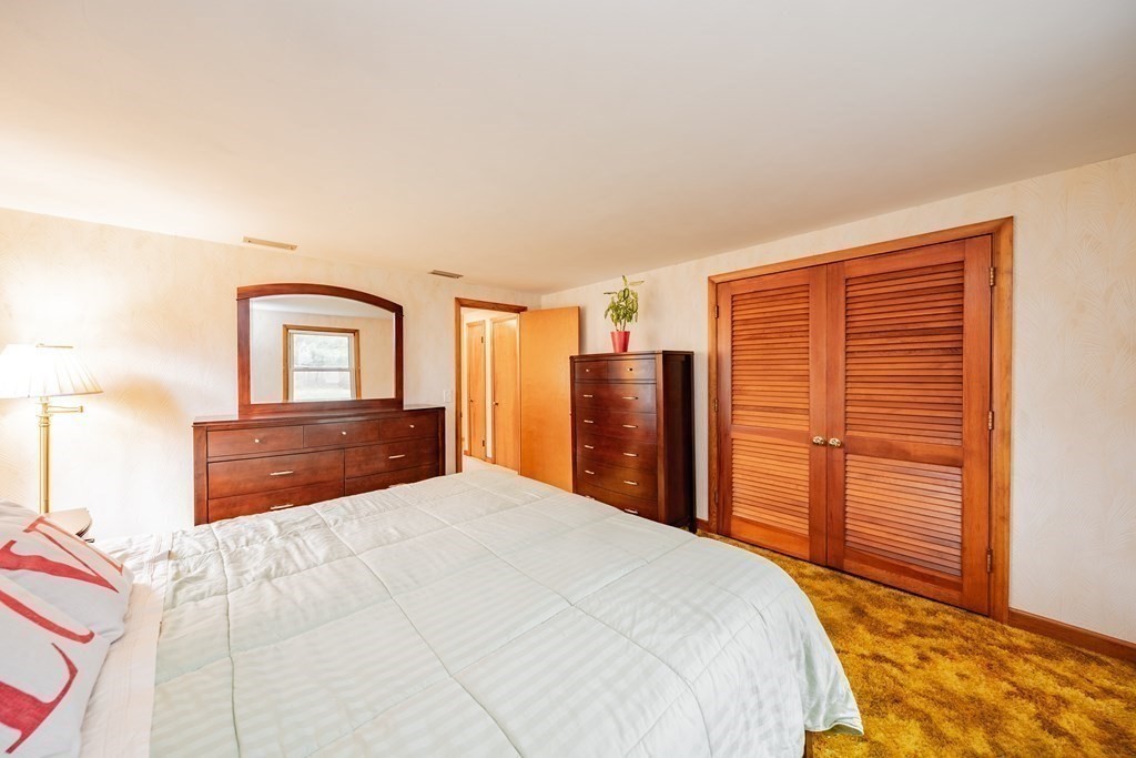 2495 Wilbraham Road Springfield, MA 01129 - Photo 22 of 42 a bedroom with a large bed and a closet