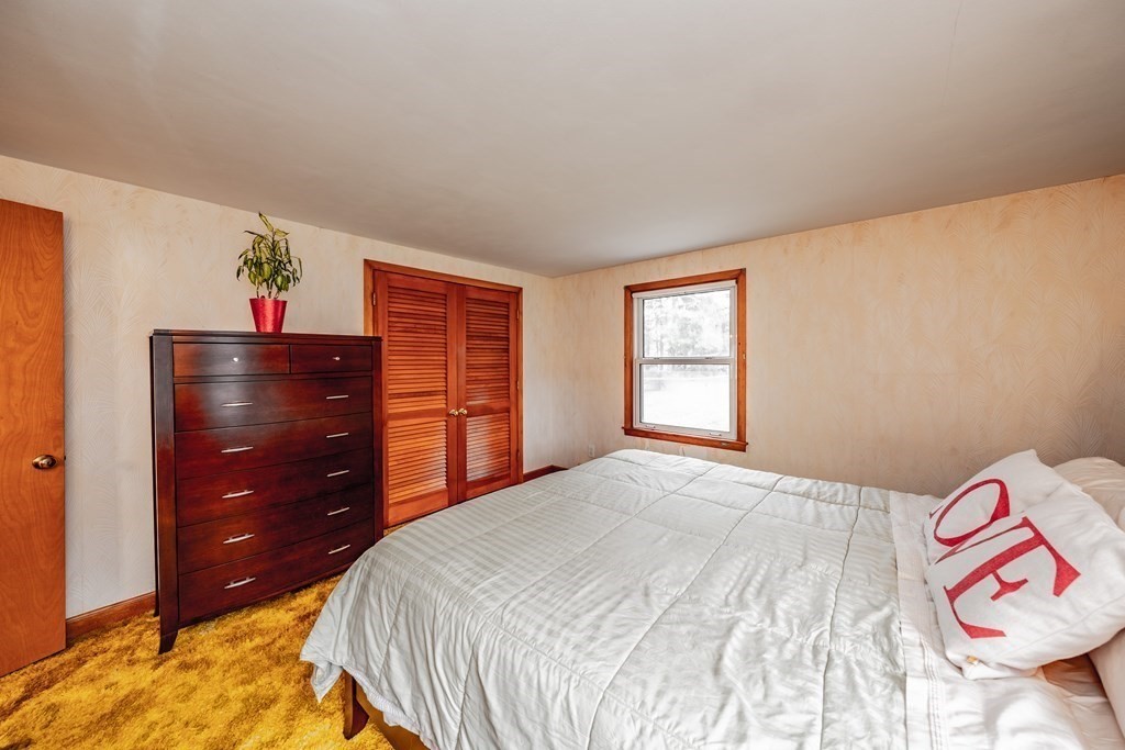 2495 Wilbraham Road Springfield, MA 01129 - Photo 23 of 42 a bedroom with a bed and a dresser