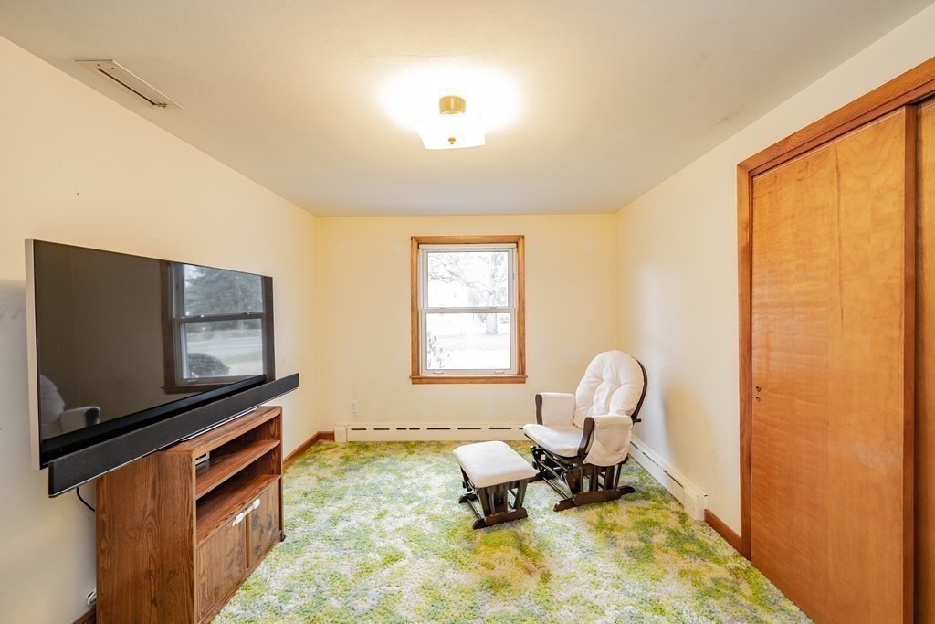 2495 Wilbraham Road Springfield, MA 01129 - Photo 29 of 42 a living room with furniture and a flat screen tv