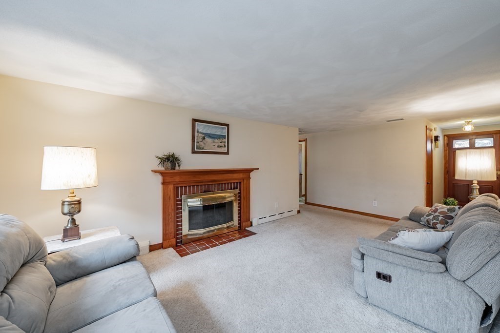 2495 Wilbraham Road Springfield, MA 01129 - Photo 8 of 42 a living room with furniture and a fireplace