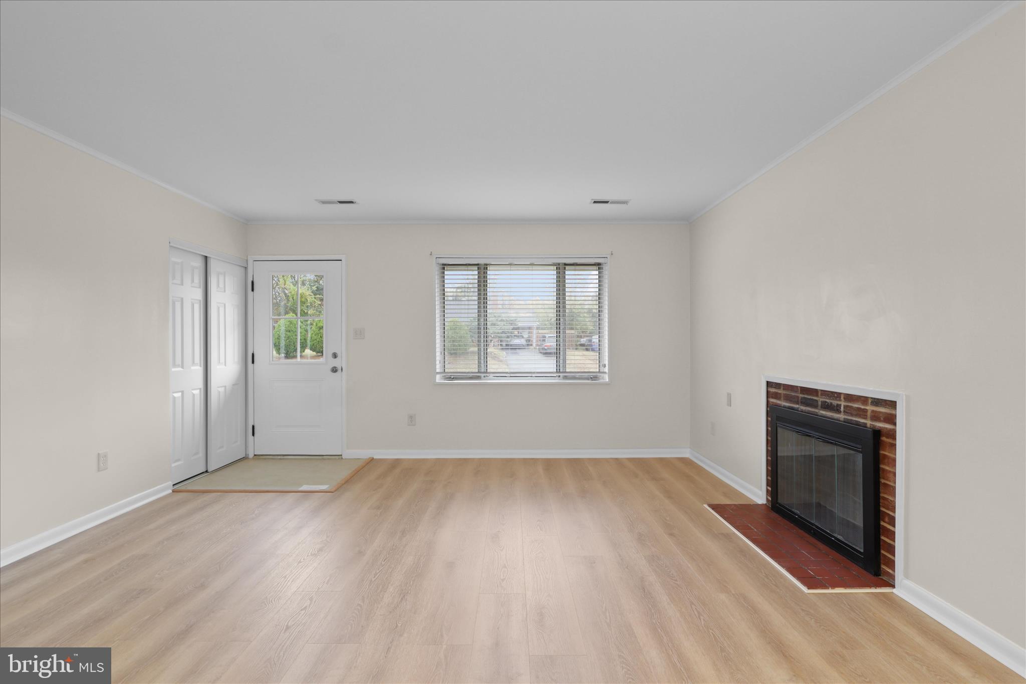 4017 Arcadia Road Alexandria, VA 22312 - Photo 4 of 25 an empty room with windows and fireplace