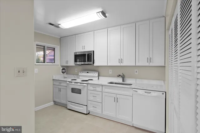 a kitchen with a sink stove and microwave
