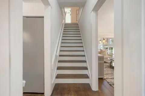 a view of a hallway with wooden floor and entryway