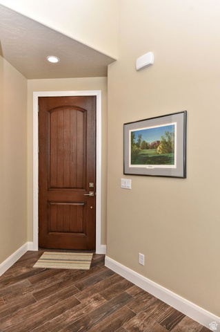 1622 Canyon Tree Drive St. George, UT 84770 - Photo 29 of 34 Entryway featuring a rich wood-finish door with an arched panel, diagonal wood-finish flooring, recessed lighting, and white baseboards