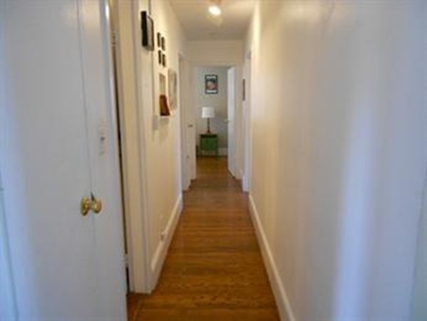 6 O'Leary Way, Unit 82 Boston, MA 02130 - Photo 4 of 14 a view of a hallway with wooden floor and a bathroom