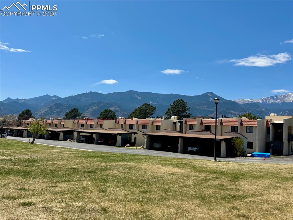 1034 Fontmore Road, Unit D Colorado Springs, CO 80904 - Photo 3 of 23 a view of a large pool with lawn chairs under an umbrella