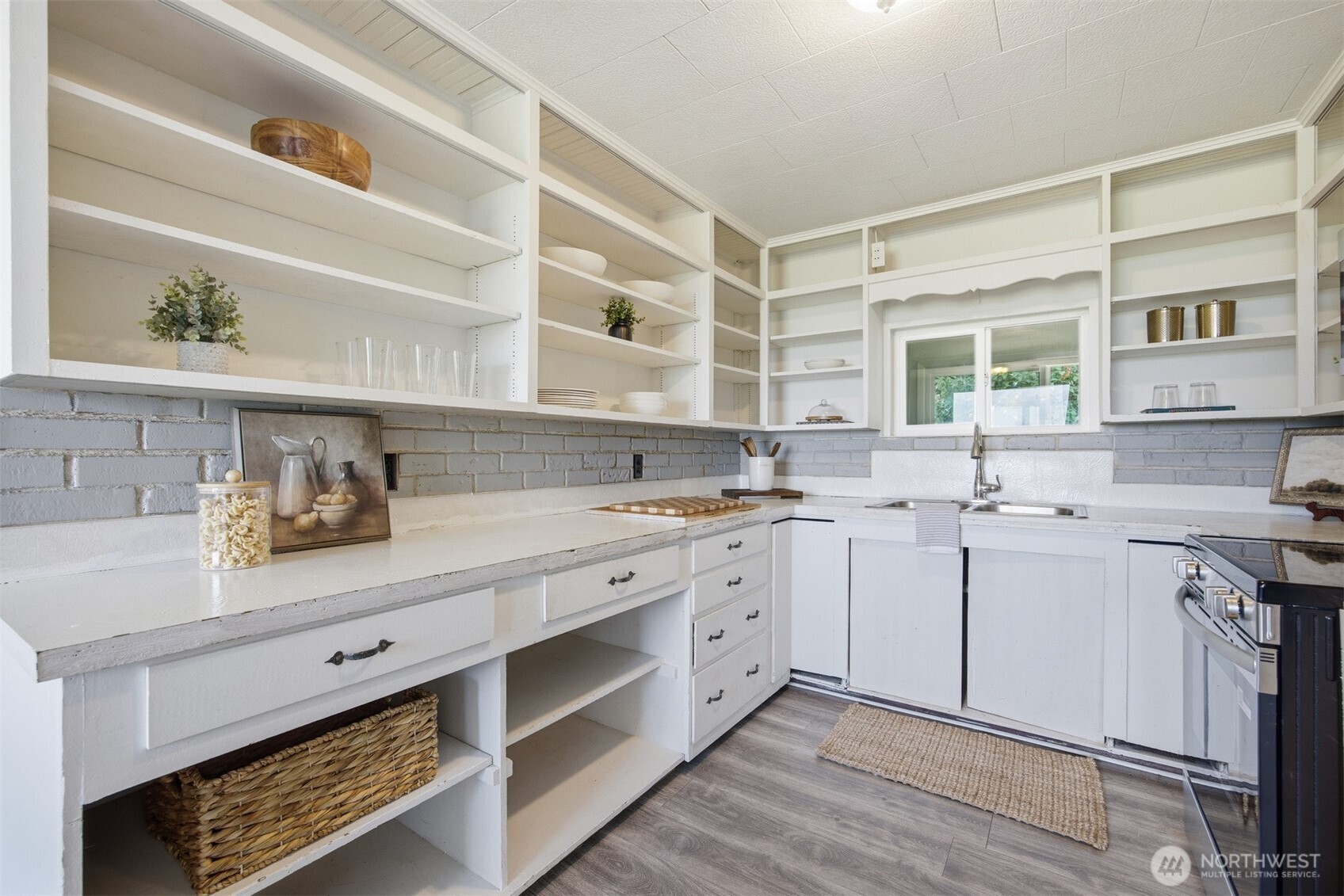 6791 Noon Road Everson, WA 98247 - Photo 11 of 38 a kitchen with white cabinets and sink