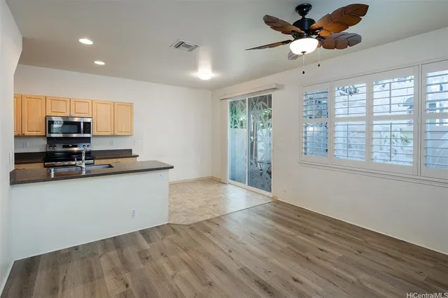 a view of kitchen with sink microwave and refrigerator