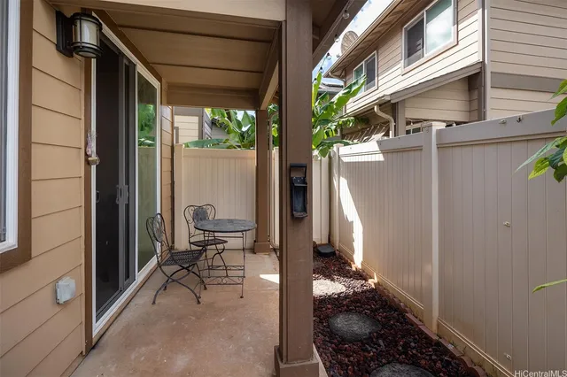 a view of a porch with chairs and a fire pit