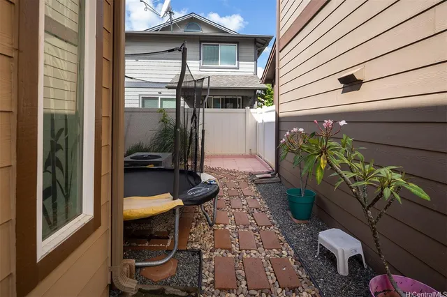 a backyard of a house with chairs