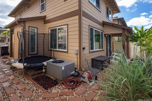 a view of a house with backyard and sitting area