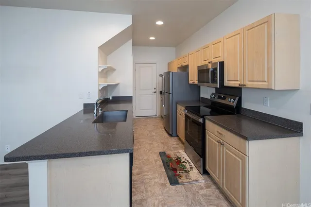 a kitchen with stainless steel appliances a sink stove and refrigerator