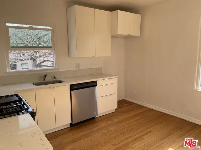 a kitchen with a white cabinets and a stove top oven