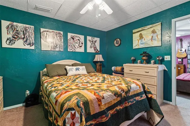 a bedroom with two beds and painting on the wall