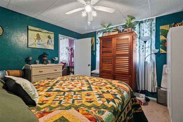a bedroom with a large bed and a chandelier