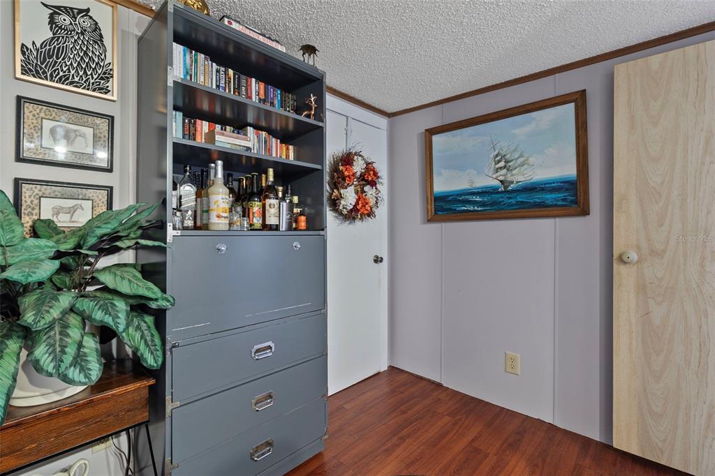 1381 Southeast Lake Road Arcadia, FL 34266 - Photo 16 of 21 a view of a hallway with wooden floor and cabinet