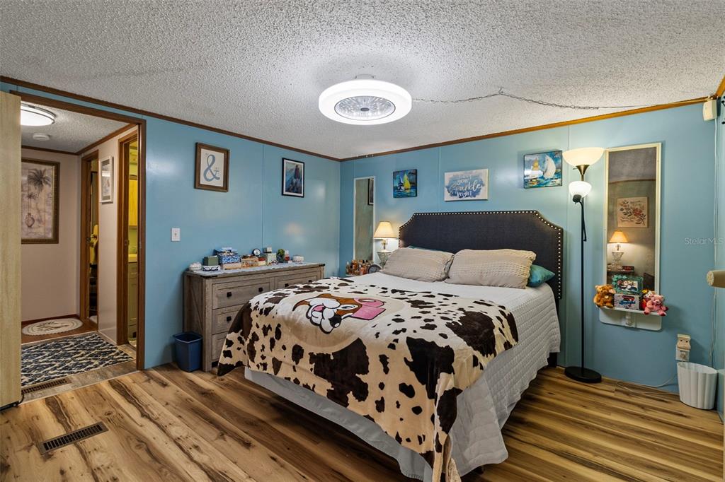 1381 Southeast Lake Road Arcadia, FL 34266 - Photo 6 of 21 a bedroom with a bed and wooden floor