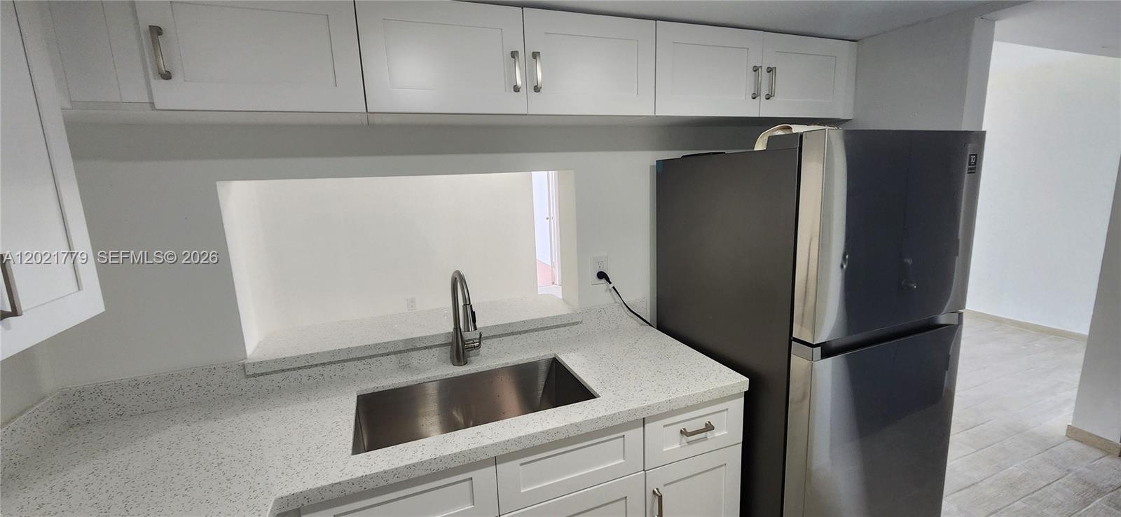 11800 Southwest 18th Street, Unit 4094 Miami, FL 33175 - Photo 5 of 14 a kitchen with a refrigerator and cabinets