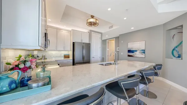 a kitchen with stainless steel appliances granite countertop a refrigerator and a sink