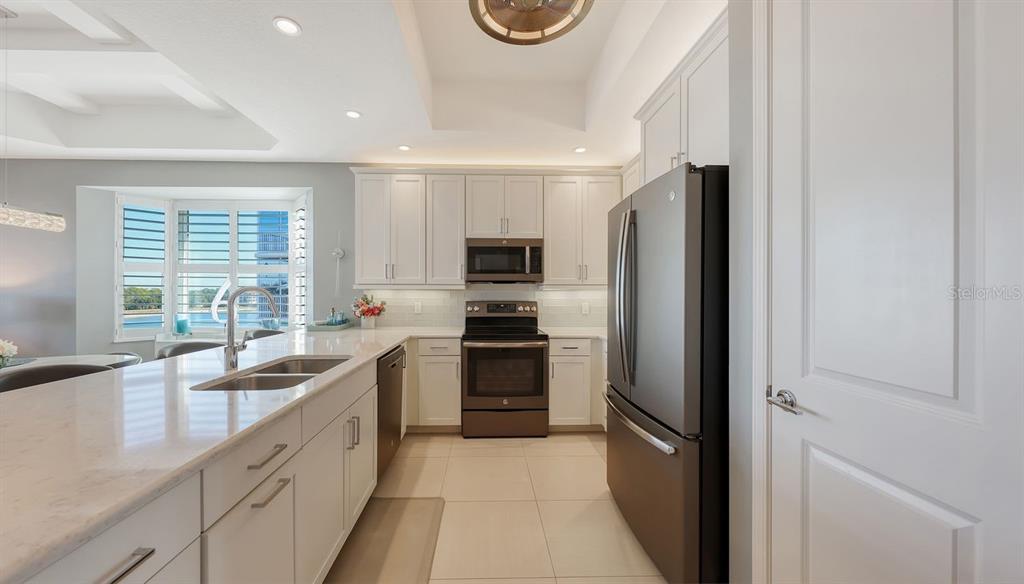 10530 Boardwalk Loop, Unit 505 Lakewood Ranch, FL 34202 - Photo 18 of 67 a kitchen with stainless steel appliances granite countertop a refrigerator and a sink