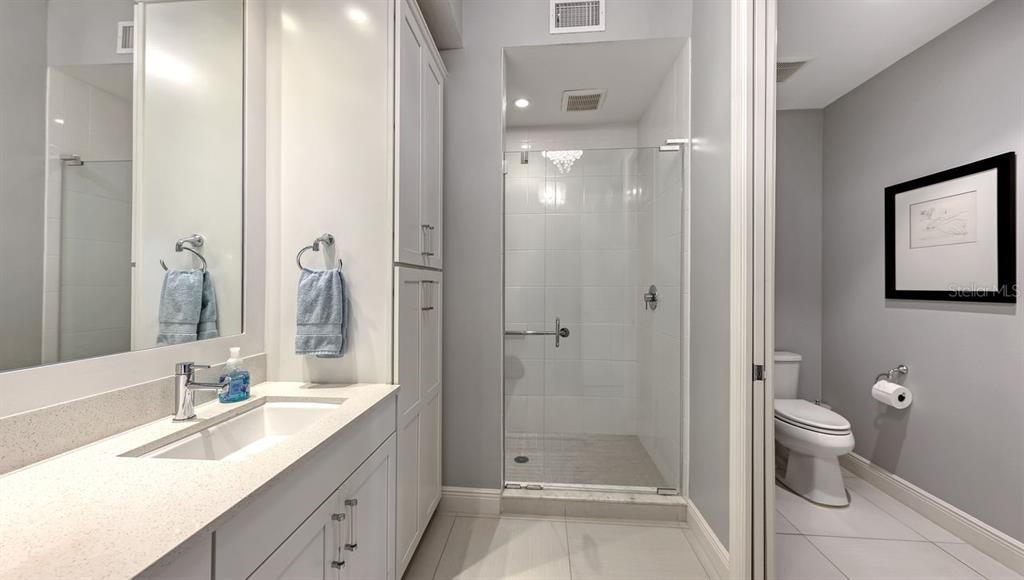 10530 Boardwalk Loop, Unit 505 Lakewood Ranch, FL 34202 - Photo 25 of 67 a bathroom with a double vanity sink toilet and shower