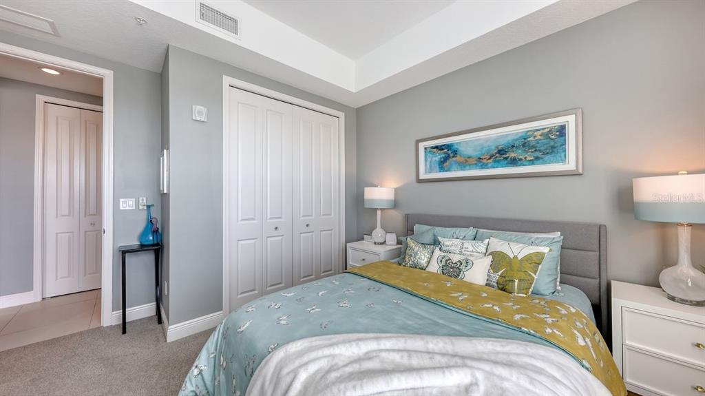 10530 Boardwalk Loop, Unit 505 Lakewood Ranch, FL 34202 - Photo 31 of 67 a bedroom with a bed and a painting on the wall