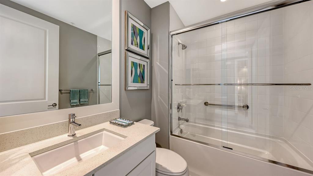 10530 Boardwalk Loop, Unit 505 Lakewood Ranch, FL 34202 - Photo 33 of 67 a bathroom with a sink a toilet and shower
