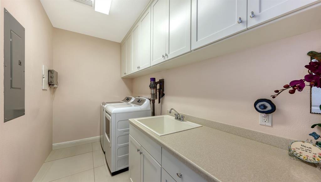 10530 Boardwalk Loop, Unit 505 Lakewood Ranch, FL 34202 - Photo 34 of 67 a bathroom with a sink and a washer dryer