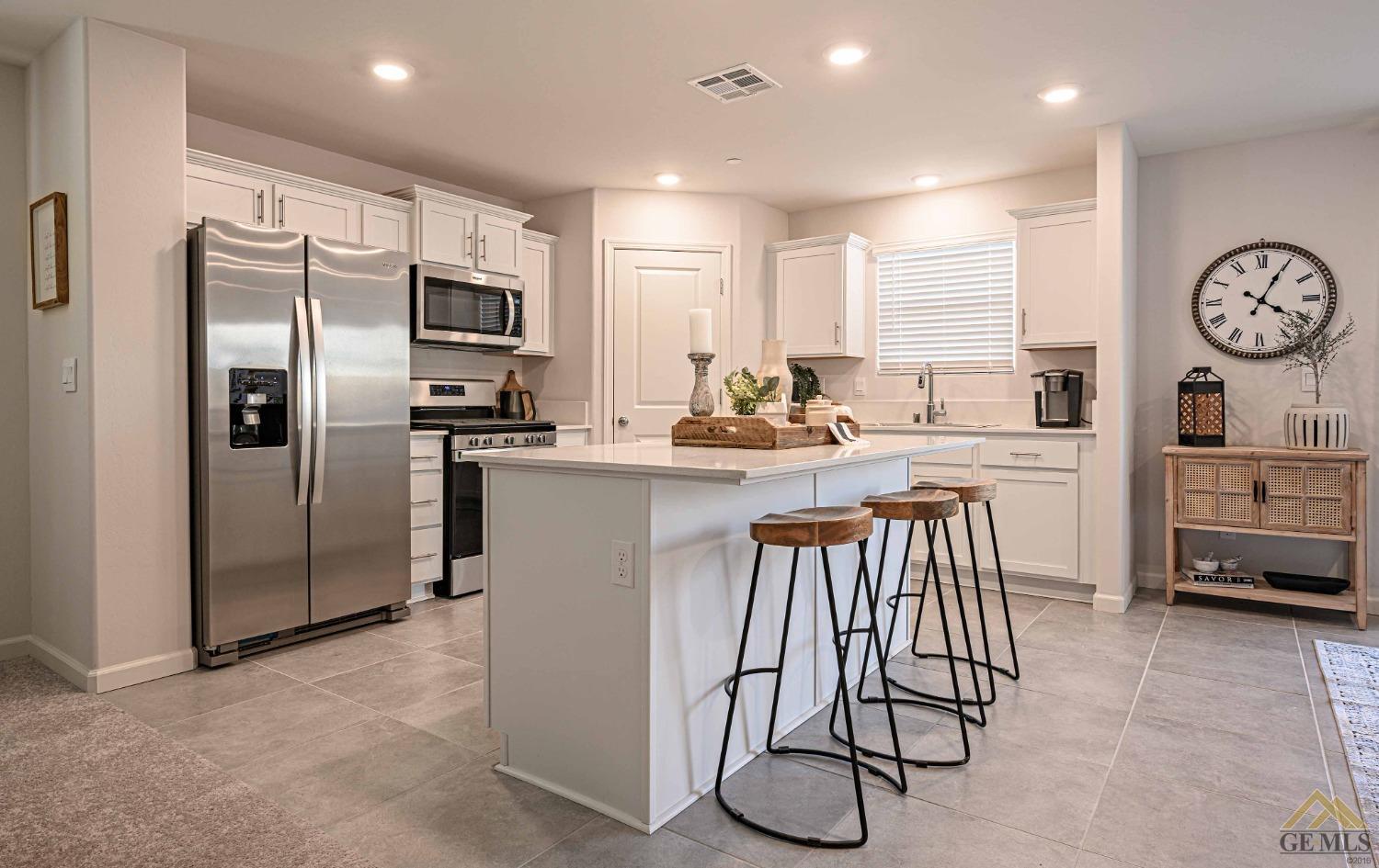 Undisclosed Address Bakersfield, CA 93313 - Photo 2 of 11 a kitchen with stainless steel appliances granite countertop a stove a sink a refrigerator and white cabinets with wooden floor