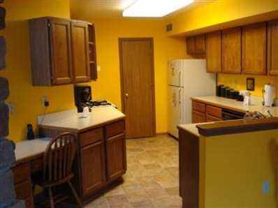 9344 Van Buren Street Crown Point, IN 46307 - Photo 6 of 10 a kitchen with a sink a stove and a refrigerator
