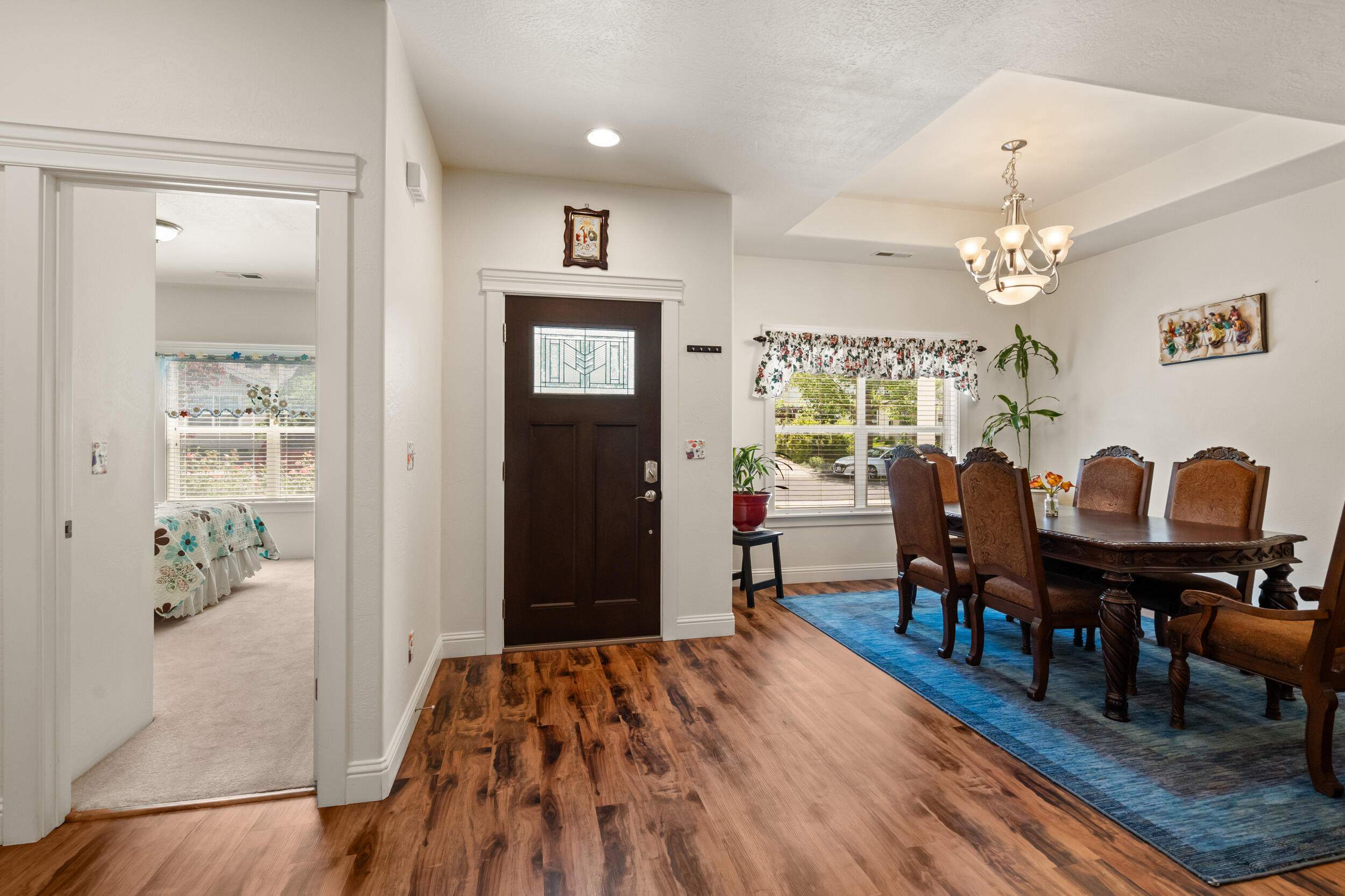 1227 Lithia Way Talent, OR 97540 - Photo 5 of 37 a workspace with wooden floor a chandelier a wooden table and chairs