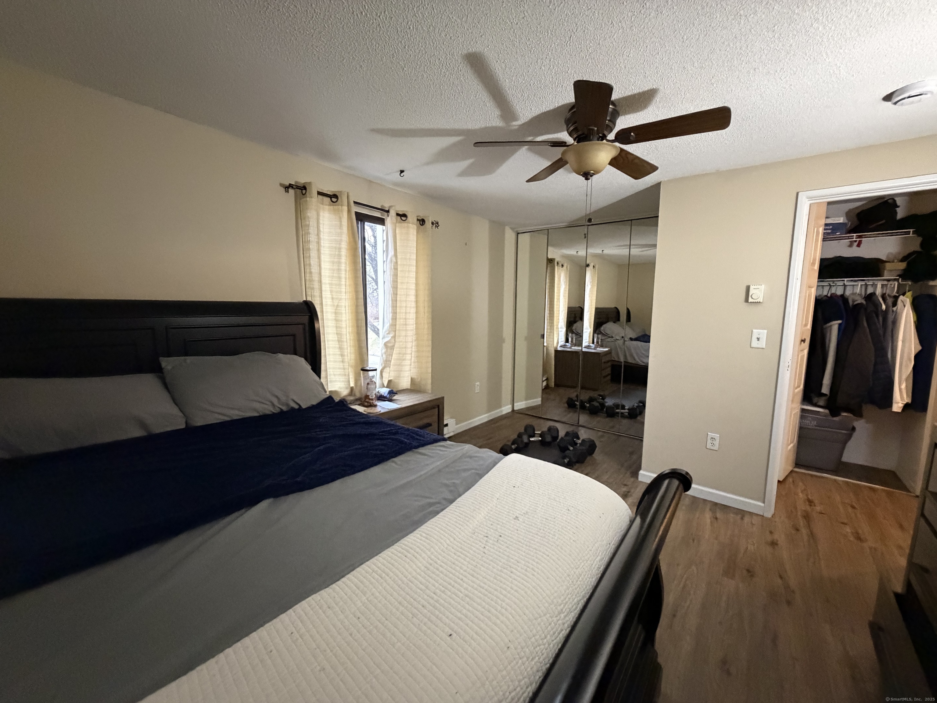 280 Burgundy Hill Lane, Unit 280 Middletown, CT 06457 - Photo 4 of 9 a bedroom with a bed and a chandelier