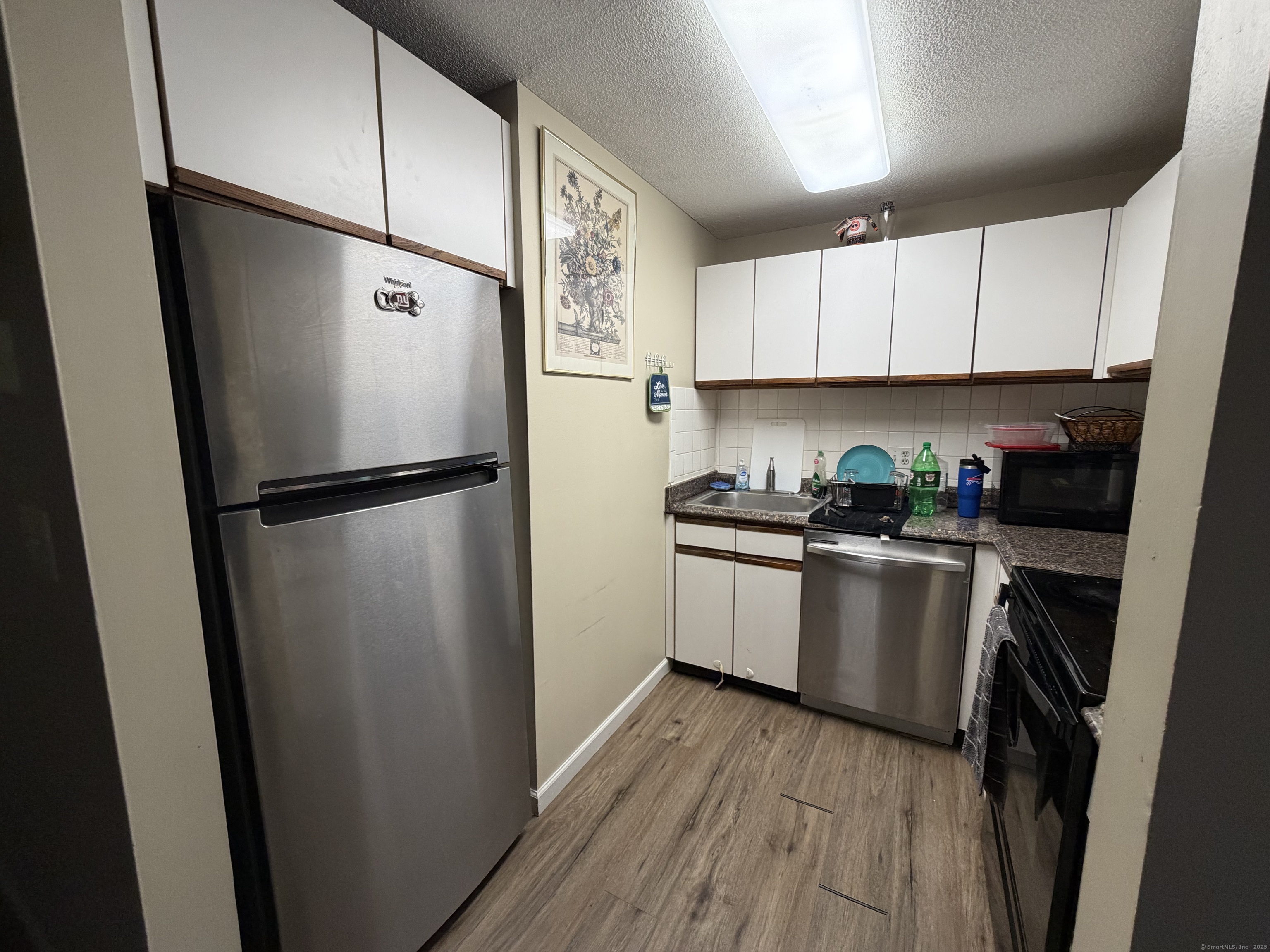 280 Burgundy Hill Lane, Unit 280 Middletown, CT 06457 - Photo 9 of 9 a kitchen with a refrigerator a sink and cabinets