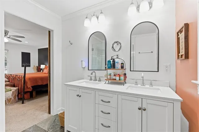 a en suite bathroom with a double vanity sink and a mirror