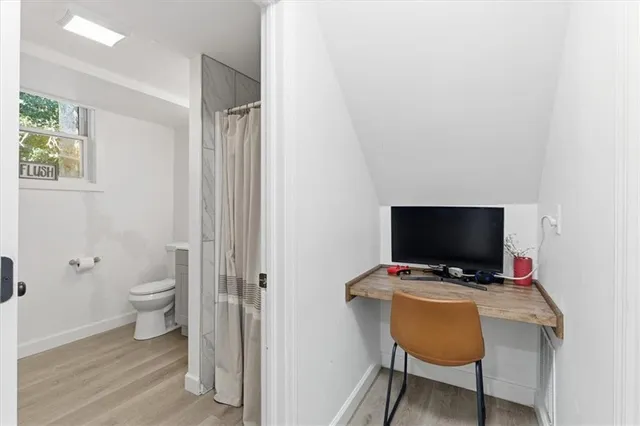 a view of a workspace with furniture and a flat screen tv