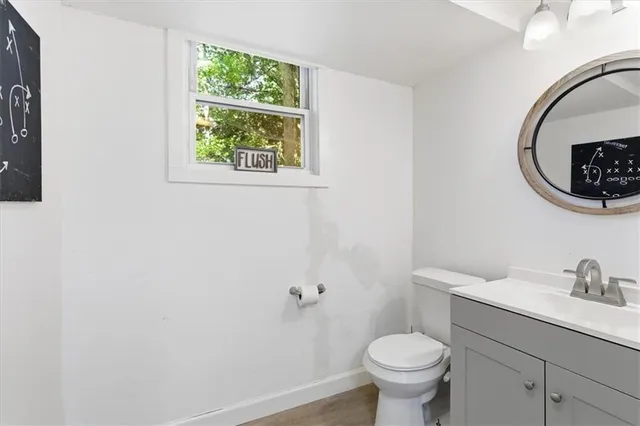 a bathroom with a toilet a sink and a window