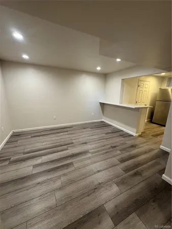 an empty room with wooden floor