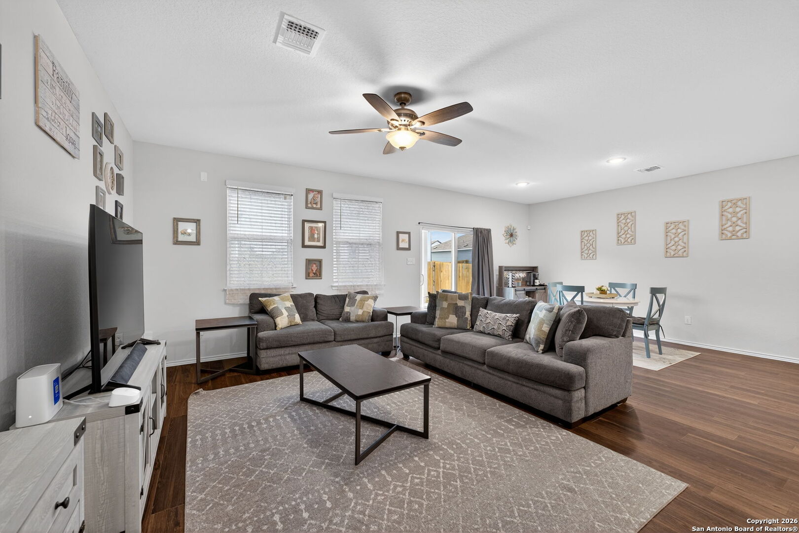 132 Bella Rosa Trail Cibolo, TX 78108 - Photo 13 of 49 a living room with furniture a ceiling fan and a rug