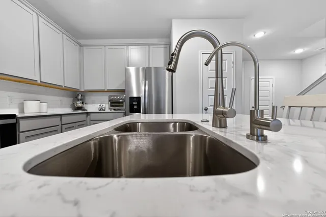 a view of a sink a counter top space in a kitchen