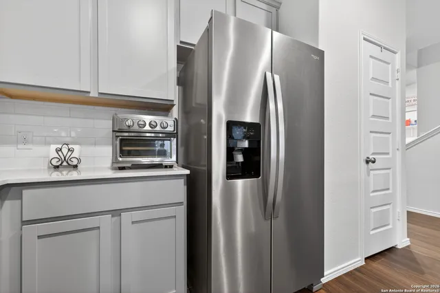 a kitchen with stainless steel appliances a refrigerator and cabinets