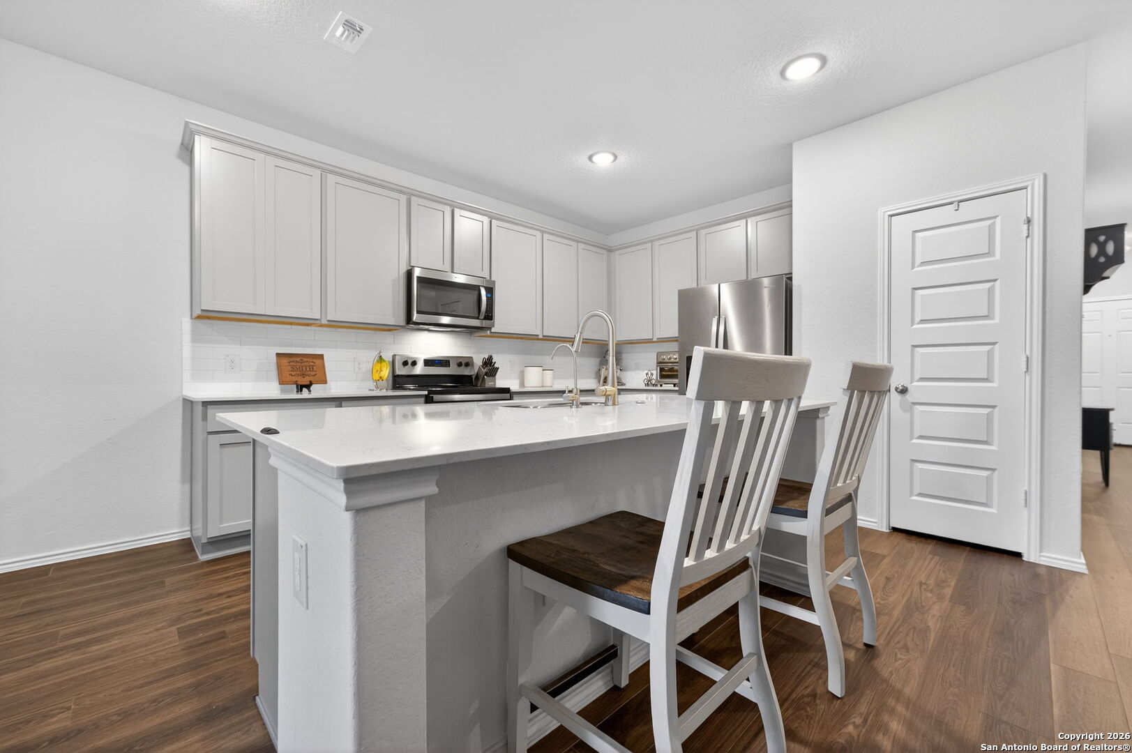 132 Bella Rosa Trail Cibolo, TX 78108 - Photo 20 of 49 a kitchen with a table chairs a sink and cabinets