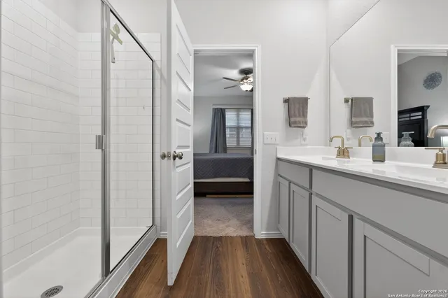 a en suite bathroom with a sink a mirror and a shower