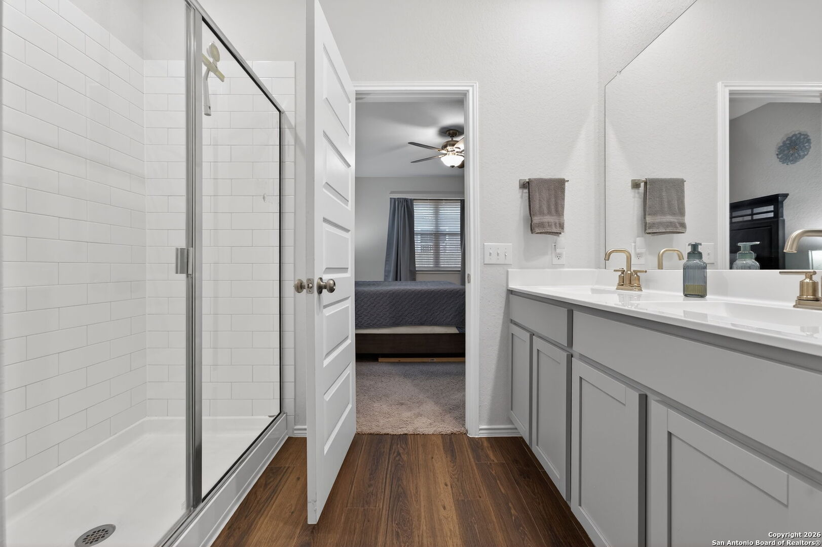 132 Bella Rosa Trail Cibolo, TX 78108 - Photo 31 of 49 a en suite bathroom with a sink a mirror and a shower