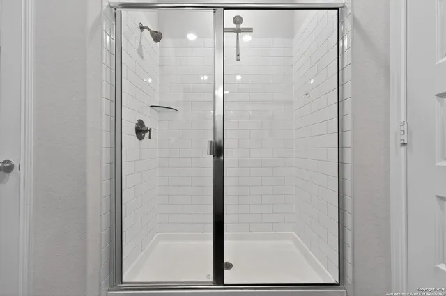 a bathroom with a glass shower door